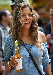 Image showing Woman, portrait and happy with cider at festival for celebration, outdoor and wellness with party. Young person, smile or face with alcohol drink for relax holiday, social fun or concert in summer