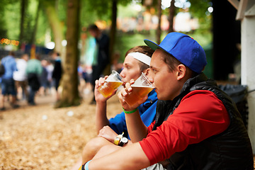 Image showing Beer, nature festival and relax friends drinking for break, wellness beverage or woods social event. Forest music concert, drunk men and outdoor people sitting with alcohol product, cup or liquid