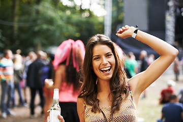 Image showing Music, festival and portrait of woman at a concert, stage and celebration with alcohol, bottle or beer at event. Happy, girl and dancing at party with audience, crowd and excited fan at techno rave