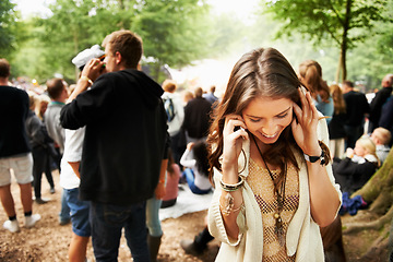 Image showing Music festival, event and woman outdoor with phone call, conversation and noise from crowd at a party. Contact, person and confused by loud, sound or listening to smartphone for communication at rave