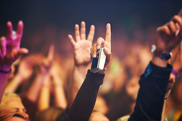 Image showing Hands, camera and a crowd of people at a music festival closeup with energy for freedom or celebration. Party, concert or event with an audience at a rock or musical performance or nightlife show