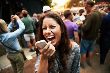 Image showing Music festival, concert and woman outdoor with phone call, shouting or energy at rave party with crowd at event. Contact, person and loud voice, sound or screaming conversation at smartphone to hear