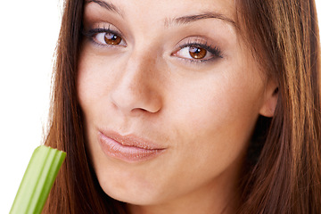 Image showing Nutrition, portrait and woman with celery in a studio for health, wellness and diet snack for lunch. Organic, weight loss and closeup face of young female model eating a vegetable by white background