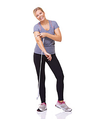 Image showing Fitness, measuring tape on arm and portrait of happy woman with smile, workout and wellness with healthy body in studio. Health, exercise and girl with weight loss measurement on white background.