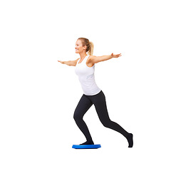 Image showing Balance, happy and fitness with woman on disk in studio for workout, mindfulness or exercise. Wellness, challenge and training with person on white background for flexibility, smile or aerobics