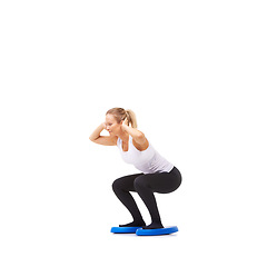 Image showing Balance, health and fitness with woman squat on disk in studio for workout, mindfulness or exercise. Wellness, challenge and training with person on white background for flexibility or aerobics