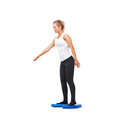 Image showing Balance, practice and fitness with woman on disk in studio for workout, mindfulness or exercise. Wellness, challenge and training with person on white background for flexibility, smile or aerobics