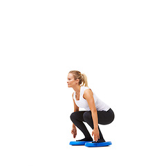 Image showing Balance, squat and workout with woman on disk in studio for health, body or exercise. Wellness, challenge and training with female person on white background for flexibility, smile or aerobics