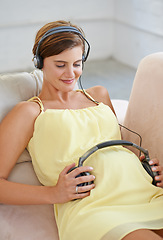 Image showing Woman, song or headphones on pregnant stomach in house living room for sound, audio or childcare listening development. Relax, pregnancy or happy person and music, podcast or wellness growth support