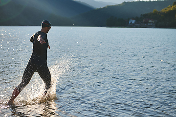 Image showing Triathlon athlete starting swimming training on lake