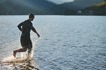 Image showing Triathlon athlete starting swimming training on lake