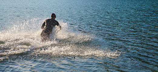 Image showing Triathlon athlete starting swimming training on lake