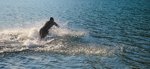 Image showing Triathlon athlete starting swimming training on lake