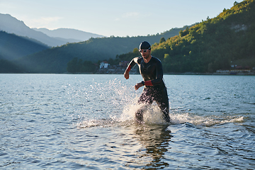 Image showing Triathlon athlete starting swimming training on lake