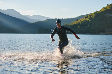 Image showing Triathlon athlete starting swimming training on lake