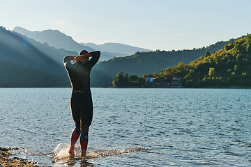 Image showing Triathlon athlete starting swimming training on lake