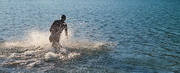 Image showing Triathlon athlete starting swimming training on lake