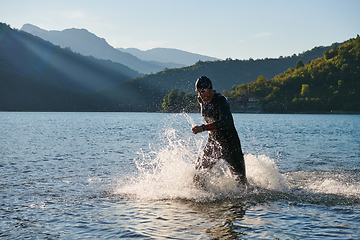 Image showing Triathlon athlete starting swimming training on lake