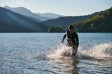 Image showing Triathlon athlete starting swimming training on lake