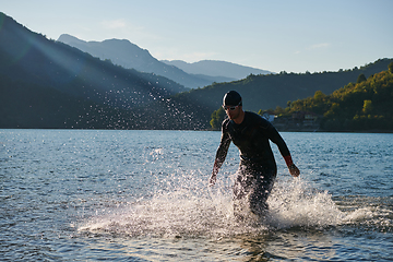 Image showing Triathlon athlete starting swimming training on lake