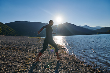 Image showing Triathlon athlete starting swimming training on lake