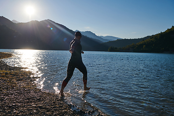 Image showing Triathlon athlete starting swimming training on lake