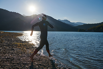 Image showing Triathlon athlete starting swimming training on lake