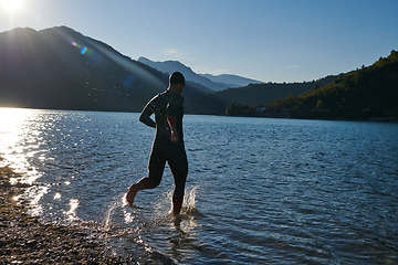 Image showing Triathlon athlete starting swimming training on lake