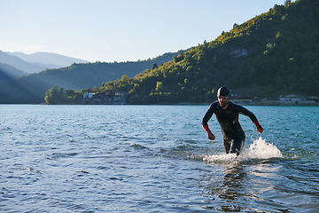 Image showing Triathlon athlete starting swimming training on lake