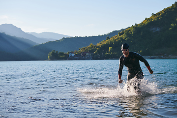 Image showing Triathlon athlete starting swimming training on lake