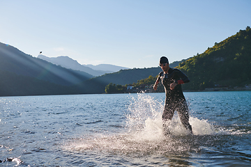 Image showing Triathlon athlete starting swimming training on lake