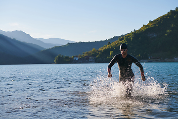 Image showing Triathlon athlete starting swimming training on lake