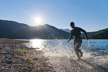 Image showing Triathlon athlete starting swimming training on lake