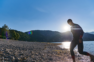 Image showing Triathlon athlete starting swimming training on lake