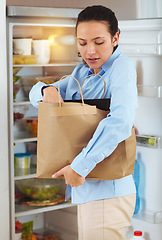 Image showing Woman, groceries and bag for packing in fridge with idea for organization of food, fruit or vegetables for diet. Female person, think and meal for nutrition, vegan and recipe with produce in home