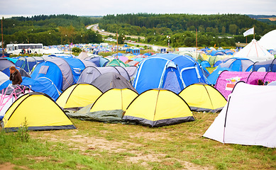 Image showing Tents, field and music festival outdoor for dancing event in forest for party celebration, rave weekend on vacation. Campsite, land and crowd for concert dj disco accommodation, park trip in nature