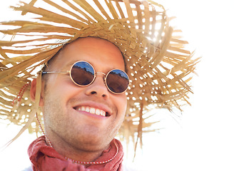 Image showing Smile, sunglasses and man in straw hat for summer outdoor, travel and holiday vacation, sunshine and mockup space. Happy young person in shades, adventure and tourist thinking, relax and fashion