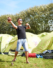 Image showing Man throw ball, camping and smile in nature outdoor at music festival, party carnival or celebration event in summer. Sports, play and person for rugby at tent, exercise game and happy to travel