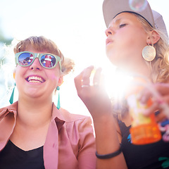 Image showing Smile, friends and women blowing bubbles outdoor in nature, play fun game at festival or freedom in summer. Happy young girls with soap at party celebration, hanging out at carnival together or flare