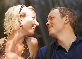 Image showing Smile, love and couple together outdoor, healthy relationship and connection in nature. Happy man, woman and romantic people looking at each other, bonding and support, trust and face profile on date