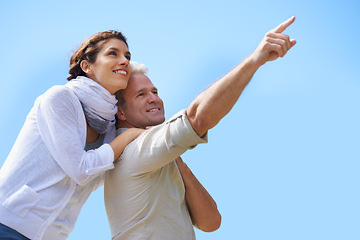 Image showing Happy, couple and outdoor pointing to sky, together with love and happiness on adventure in summer. Vacation, travel and woman hug mature man sightseeing on holiday with mockup, space or background