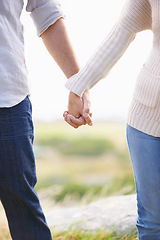 Image showing Couple, holding hands and closeup on holiday with love, trust and support on vacation journey together. Marriage, man and woman in nature, walking with care and respect for partnership or bonding