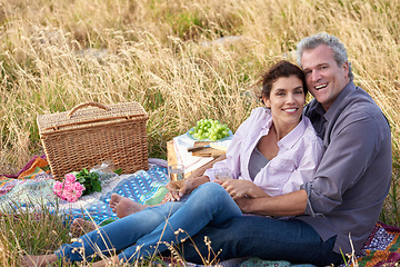 Image showing Old couple, relax and portrait of picnic in park for a date with love, care or support in marriage. Happy, man and woman on grass with food, flowers and celebration in retirement, holiday or vacation