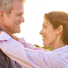 Image showing Old couple, smile and embrace at sunset with love, trust and support in marriage and retirement. Happy, woman and care for partner on holiday with freedom, health and wellness at the beach for cruise