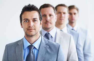 Image showing Men, portrait and serious for future finance career, standing and ready for job interview. Worker, corporate accountant in suit or professional in workplace, colleagues in background and confident