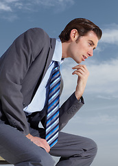 Image showing Thinking, planning and a business man on a blue sky background for corporate vision or development. Profile, idea and future with a young professional employee in a suit outdoor for company growth