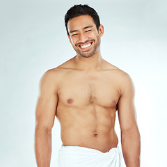 Image showing Body, cleaning and happy asian man in a towel in studio for beauty, hygiene and care on grey background. Face, smile and muscular Japanese male model with glowing skin grooming results after shower