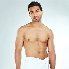 Image showing Chest, body and portrait of asian man in a towel in studio for cleaning, hygiene and care on grey background. Face, confidence muscular Japanese model with glowing skin grooming results after shower