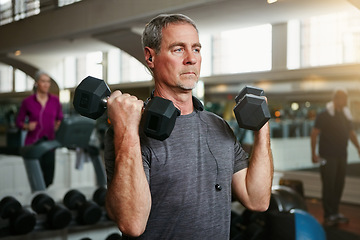 Image showing Senior fitness, old man and dumbbells at a gym for weightlifting, challenge or workout, training or bodybuilding. Biceps, arms and elderly person with hand weight for strength, mindset or exercise