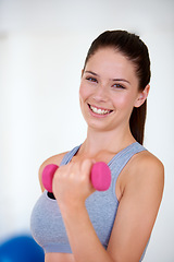 Image showing Woman, sports bra and portrait with dumbbells in studio for health wellness, training and weight loss with exercise. Young person, happy and face with hand weights for tone muscle with fitness in gym